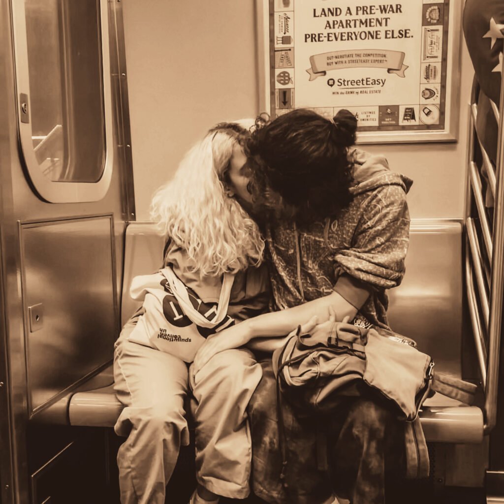 Couple kissing on a subway car