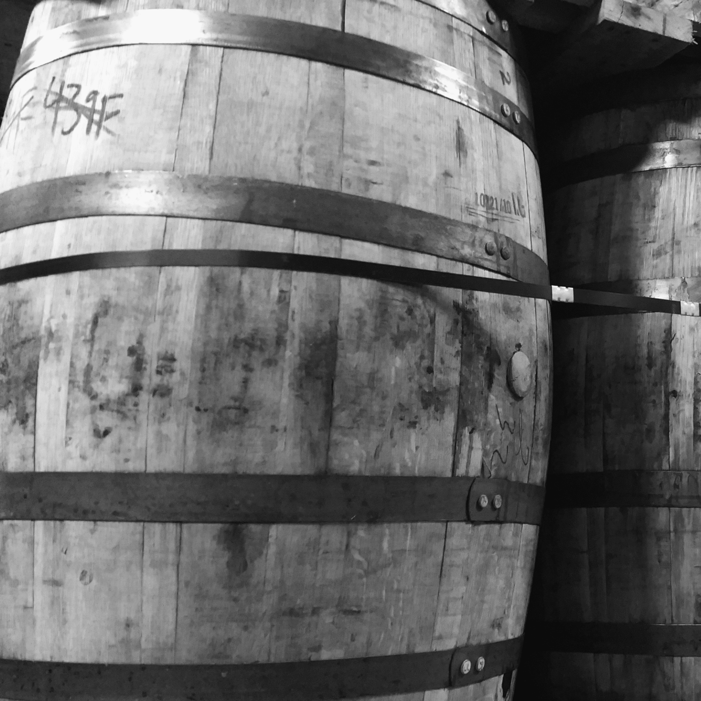 Whisky barrel in black and white in worn condition